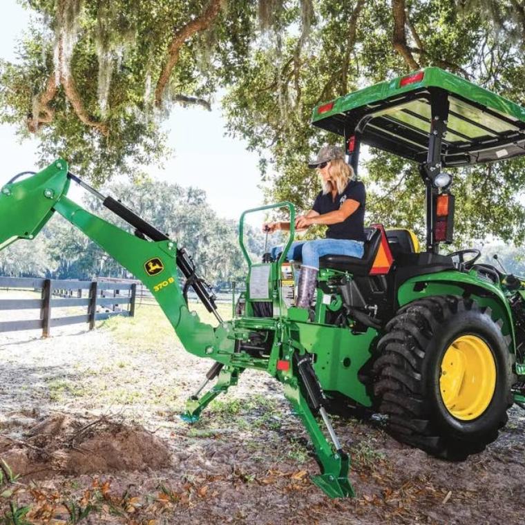 Deere posts first profit gain in three years, raises outlook